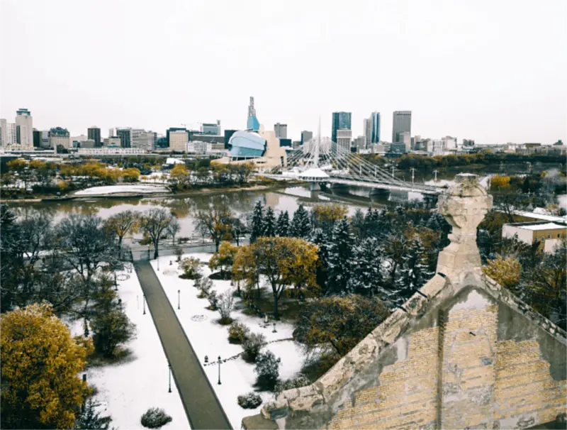 Downtown Winnipeg across the Red River, with the Canadian Museum for Human Rights and the Esplanade Riel, after an early snowfall.